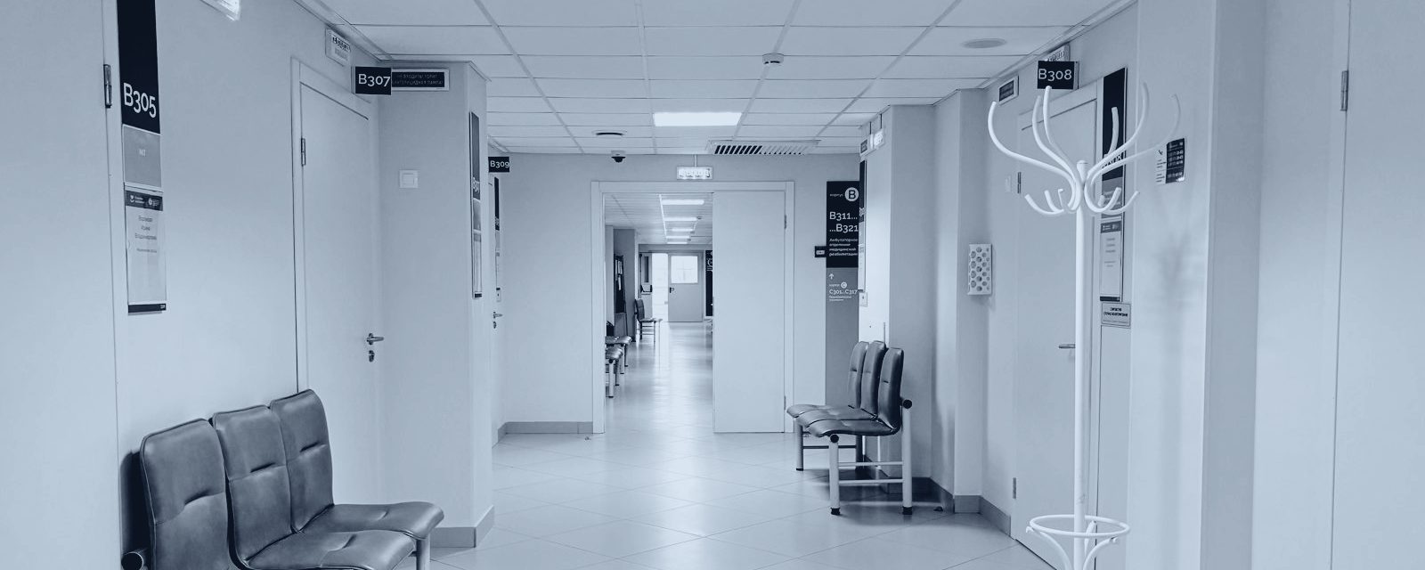 Empty healthcare corridor in slate duotone — atmospheric imagery